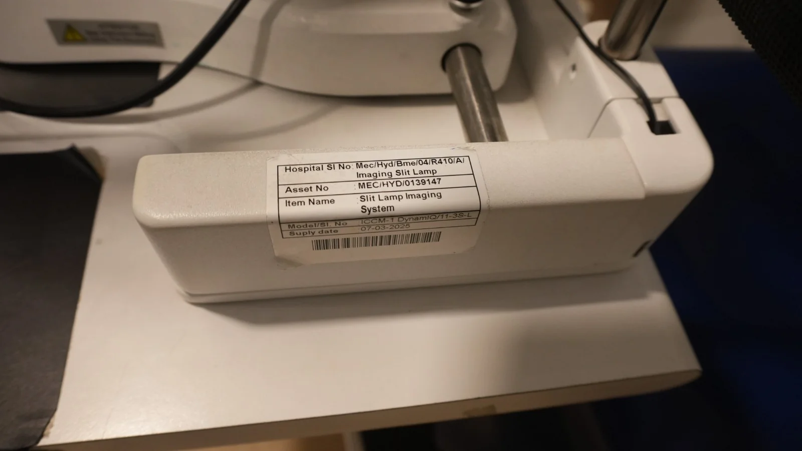 Imaging slit lamp carrying its hospital asset label