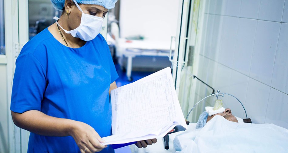 Reception team assisting a patient at the front desk