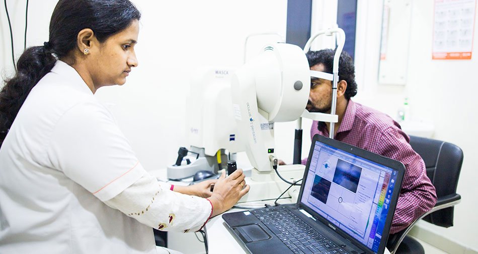 Consultant examining a patient at the slit lamp