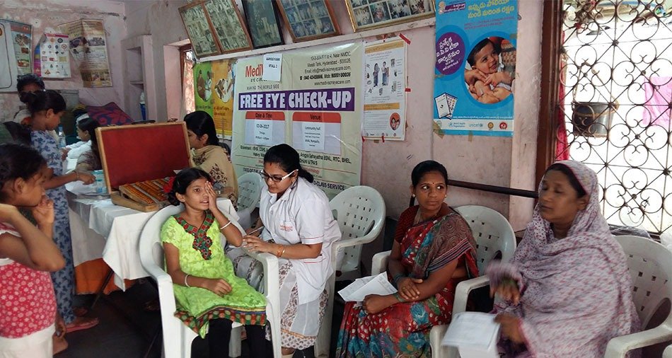 Reading chart test being conducted in the open at a camp