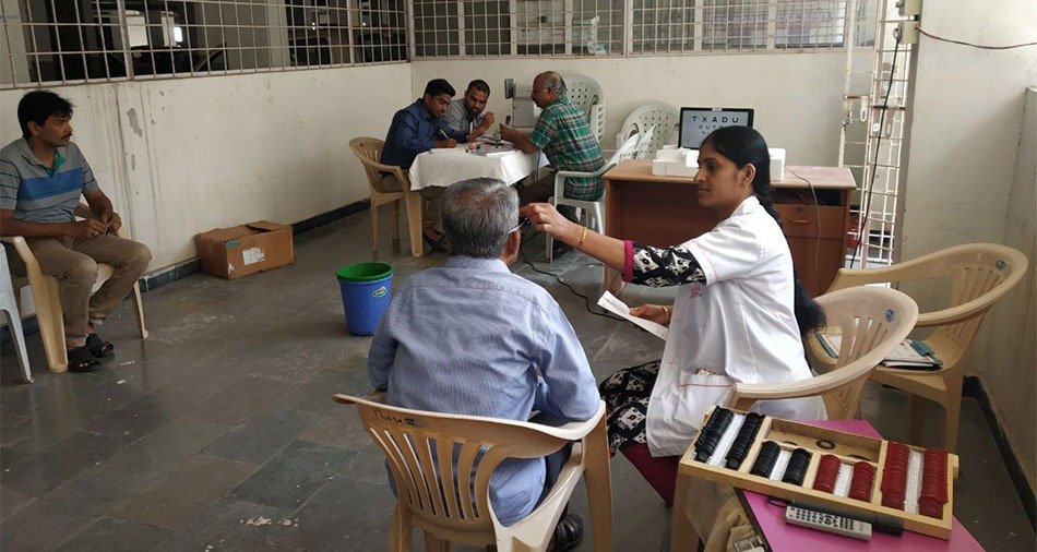 Camp team setting up equipment in a village hall