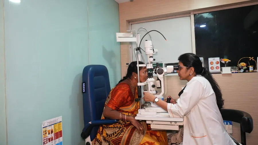 Consultant examining the front of the eye at the slit lamp
